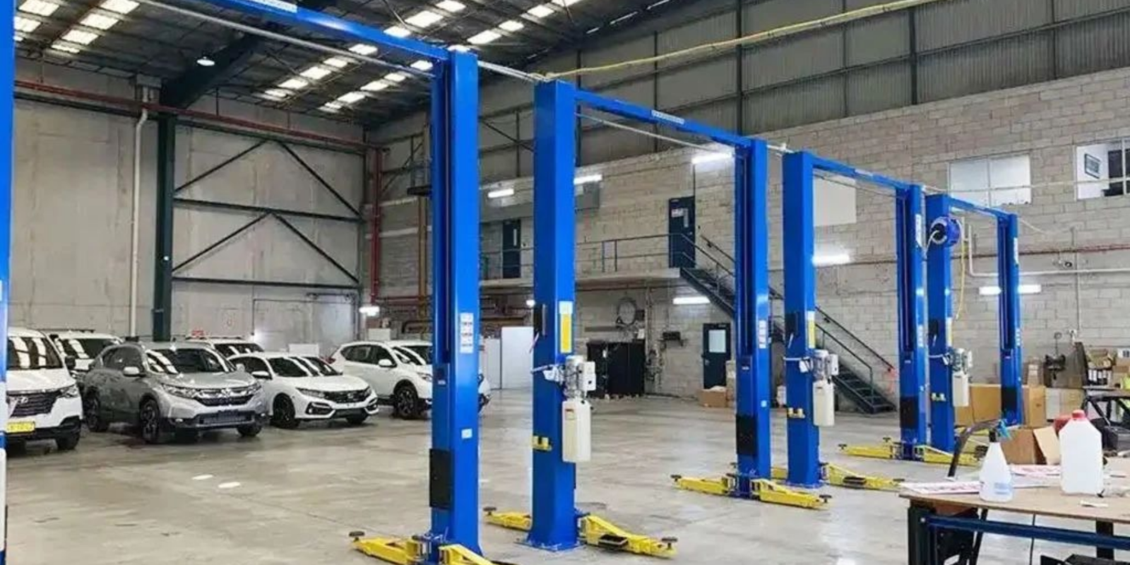 Automotive two post vehicle lift in workshop