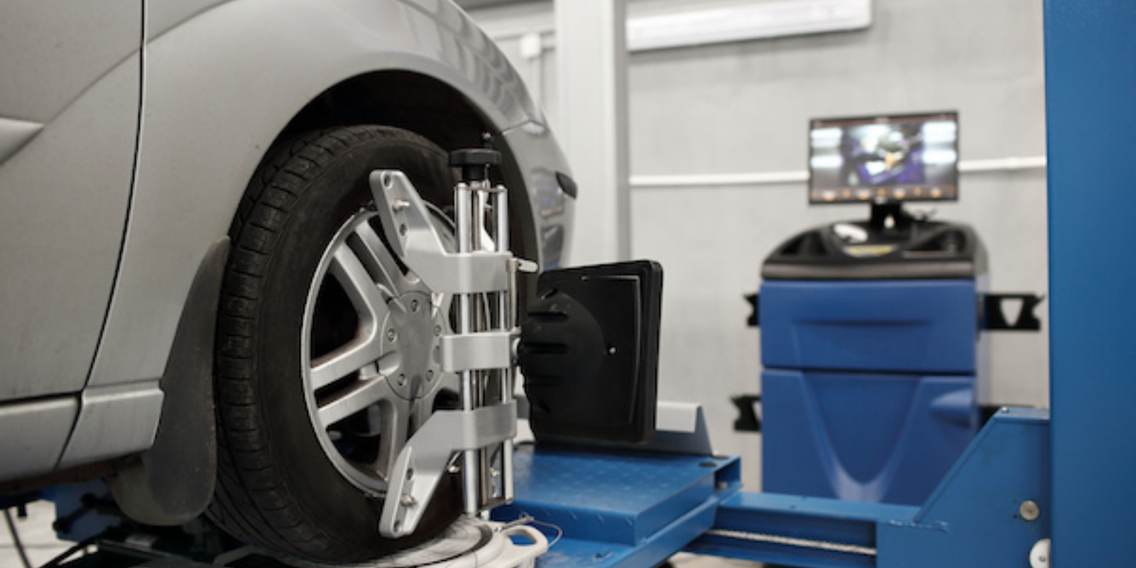 Wheel alignment and tyre service equipment in automotive workshop